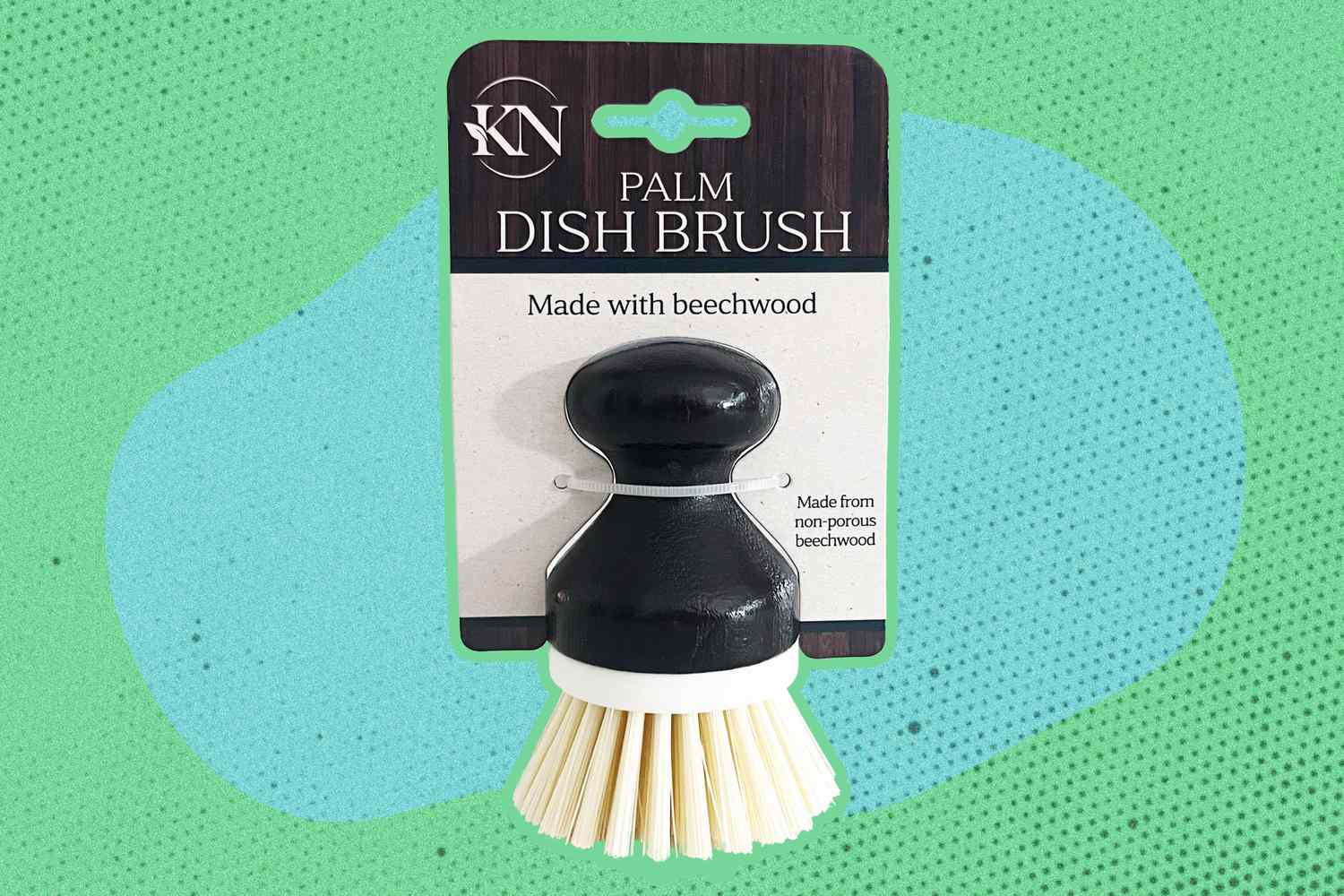 Palm dish brush with a label stating it is made with beechwood
