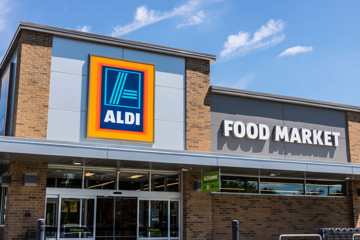 Ground level view of an Aldi storefront with the Aldi logo visible above the doors