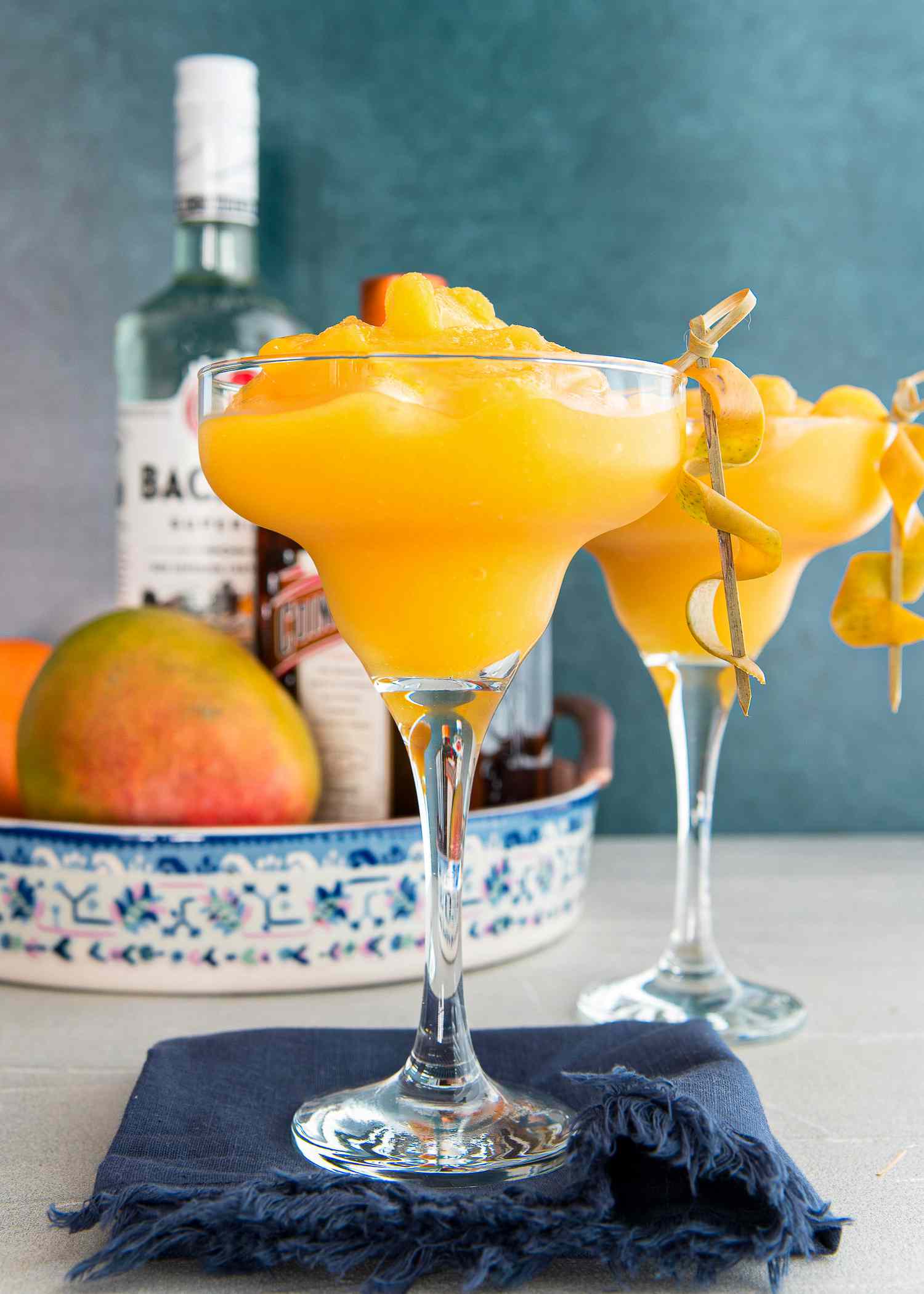 Frozen mango daiquiris in martini glasses.