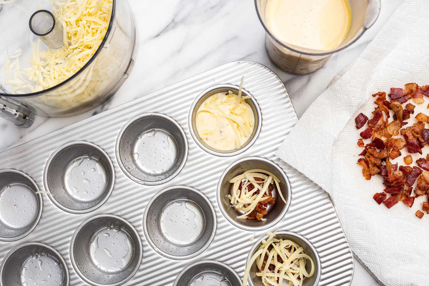 Bacon and Gruyère Added to Muffin Tin and Topped with Egg Mixture for Egg Bites Recipe