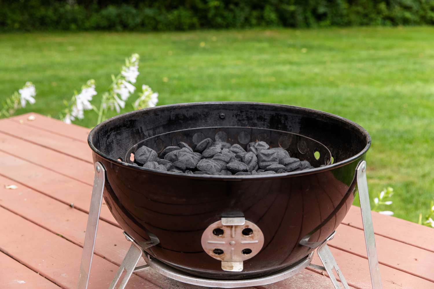 A charcoal grill outside to make a smoked turkey.