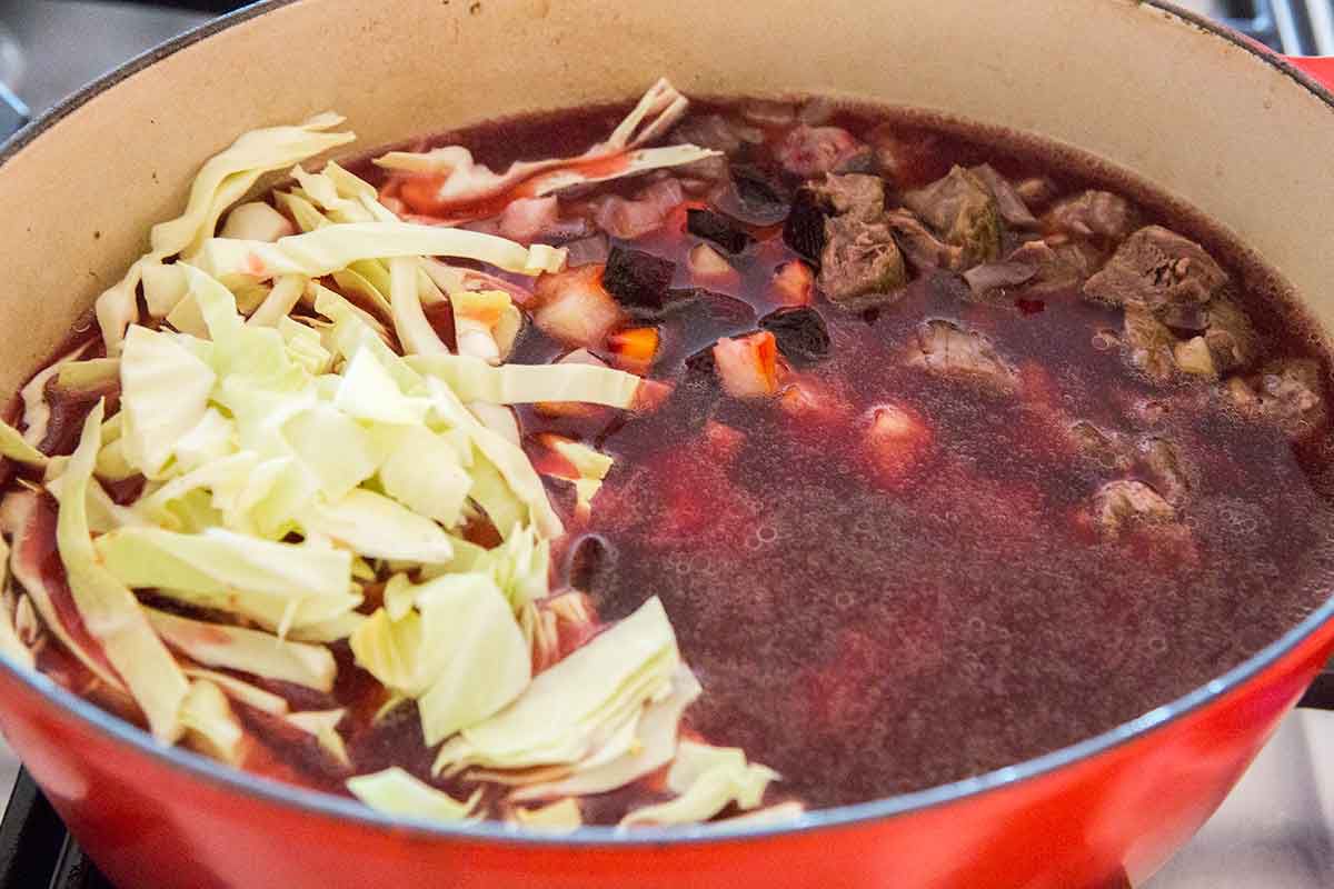 Ingredients for borscht in a Dutch oven