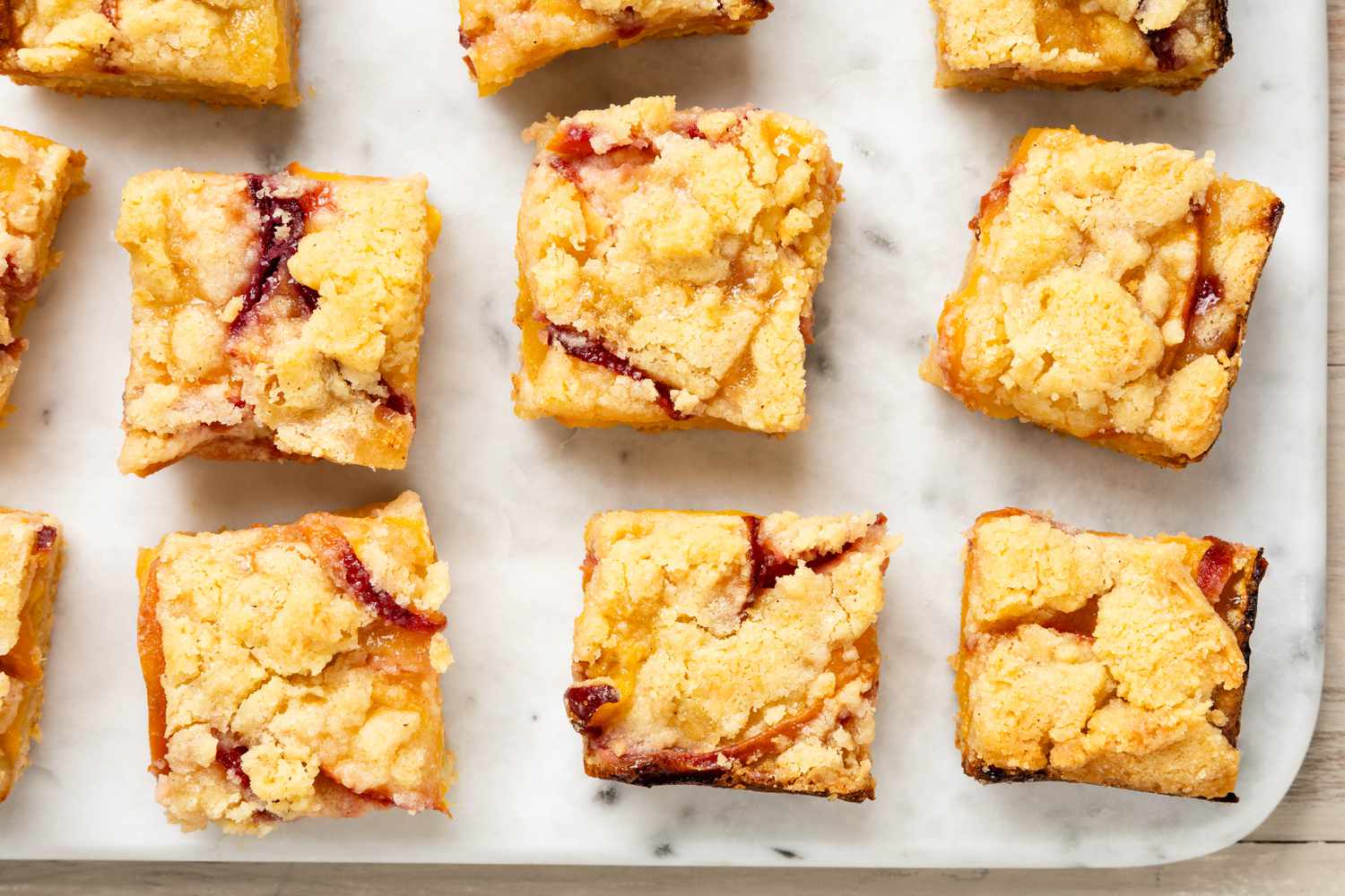 Overhead shot of peach pie bars on marble counter