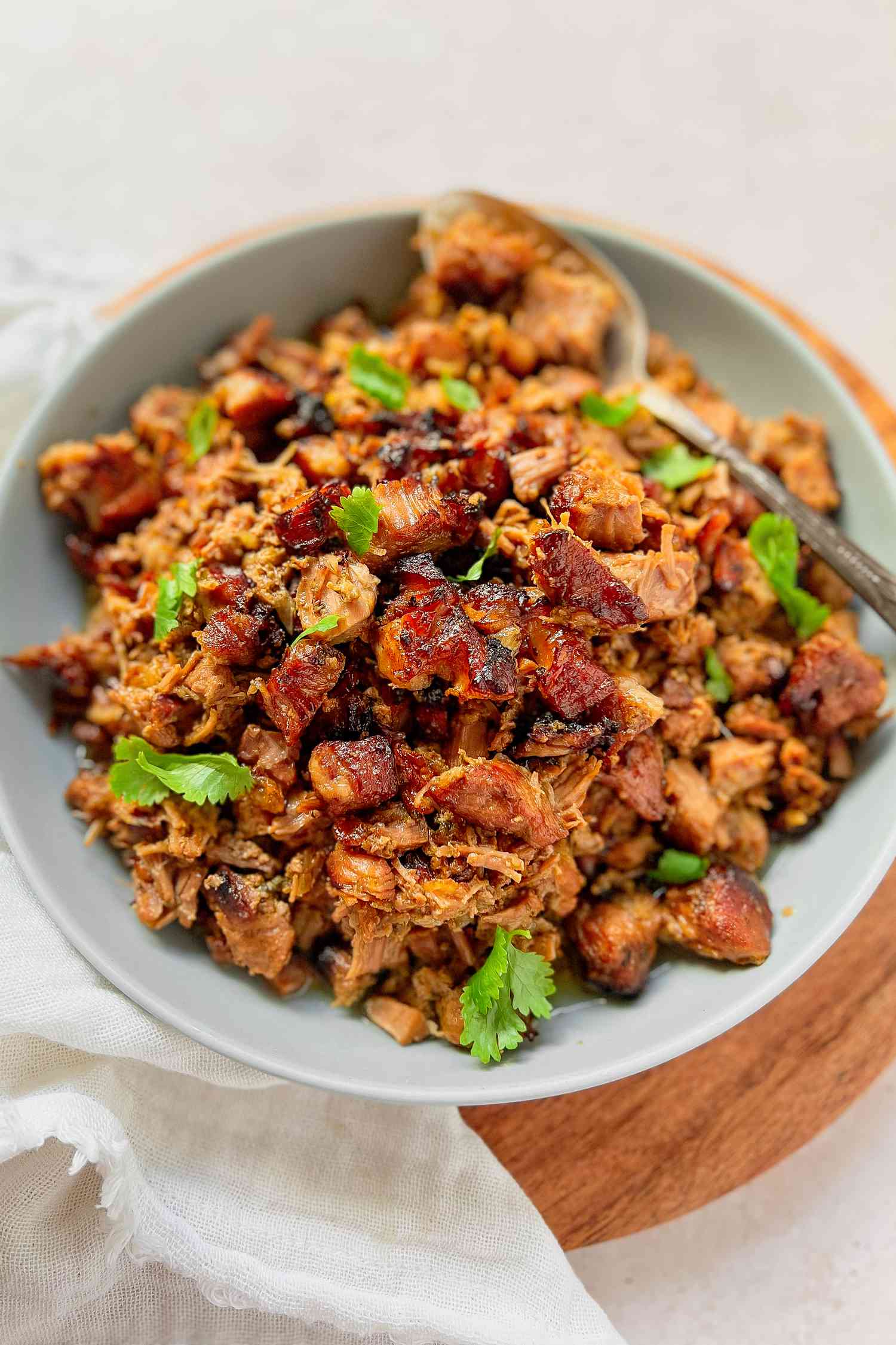 Carnitas in a Bowl with a Serving Spoon