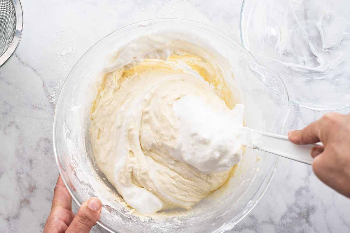 Mexican Tres Leches Cake add the egg whites to yolks and cake flour