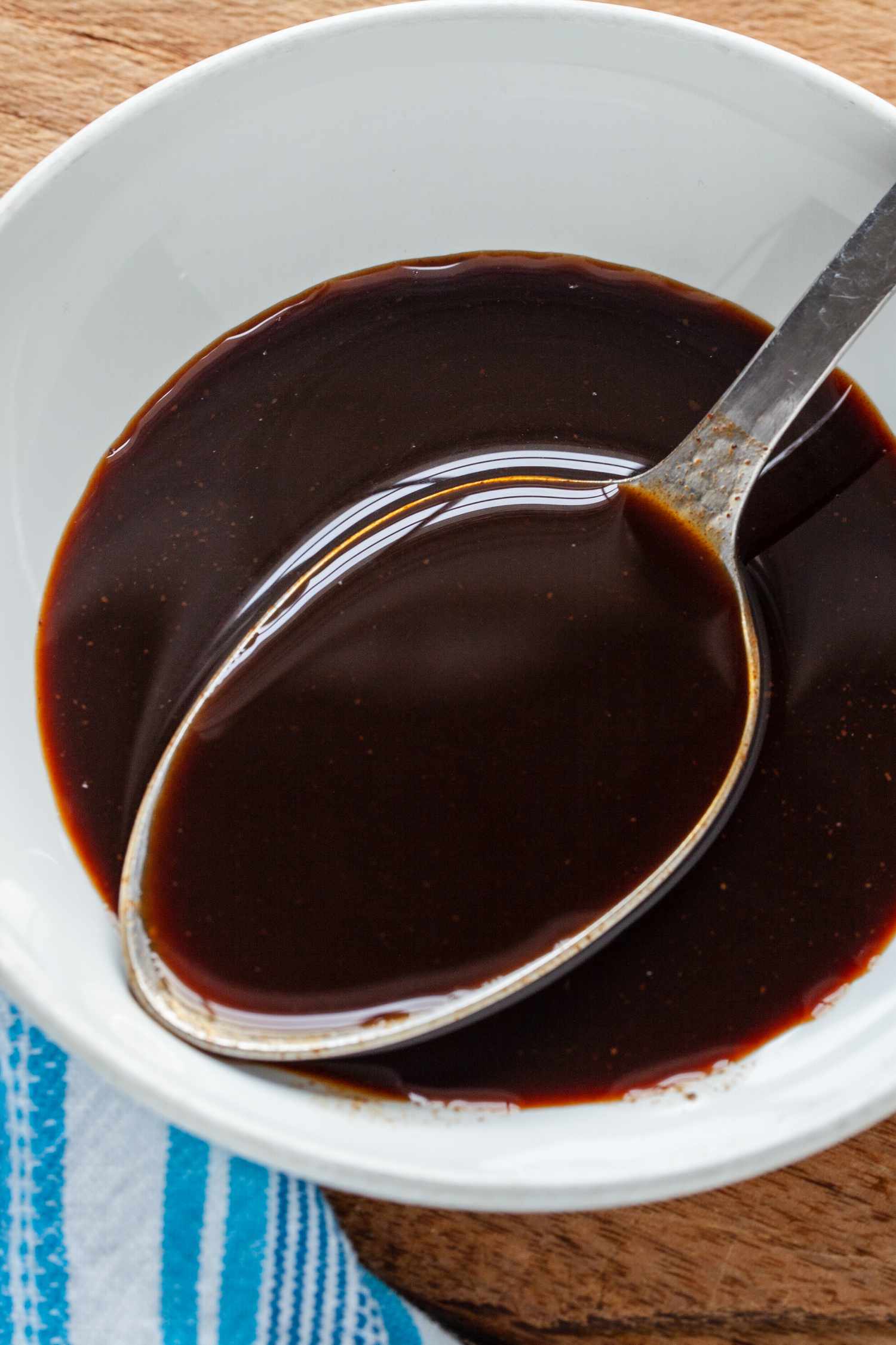 Spoonful of Homemade Worcestershire Sauce Lifted from a Bowl