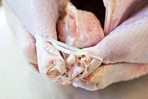 Close up of a whole turkey with its legs tied for a turkey recipe.