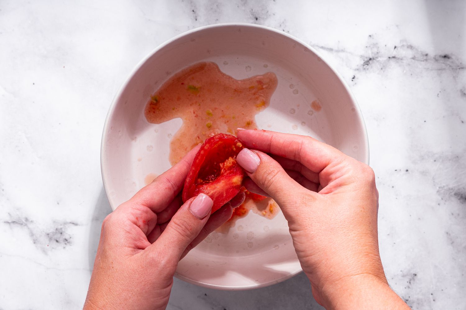 Tomato seeds removed from tomato quarters for bruschetta with tomato and basil recipe