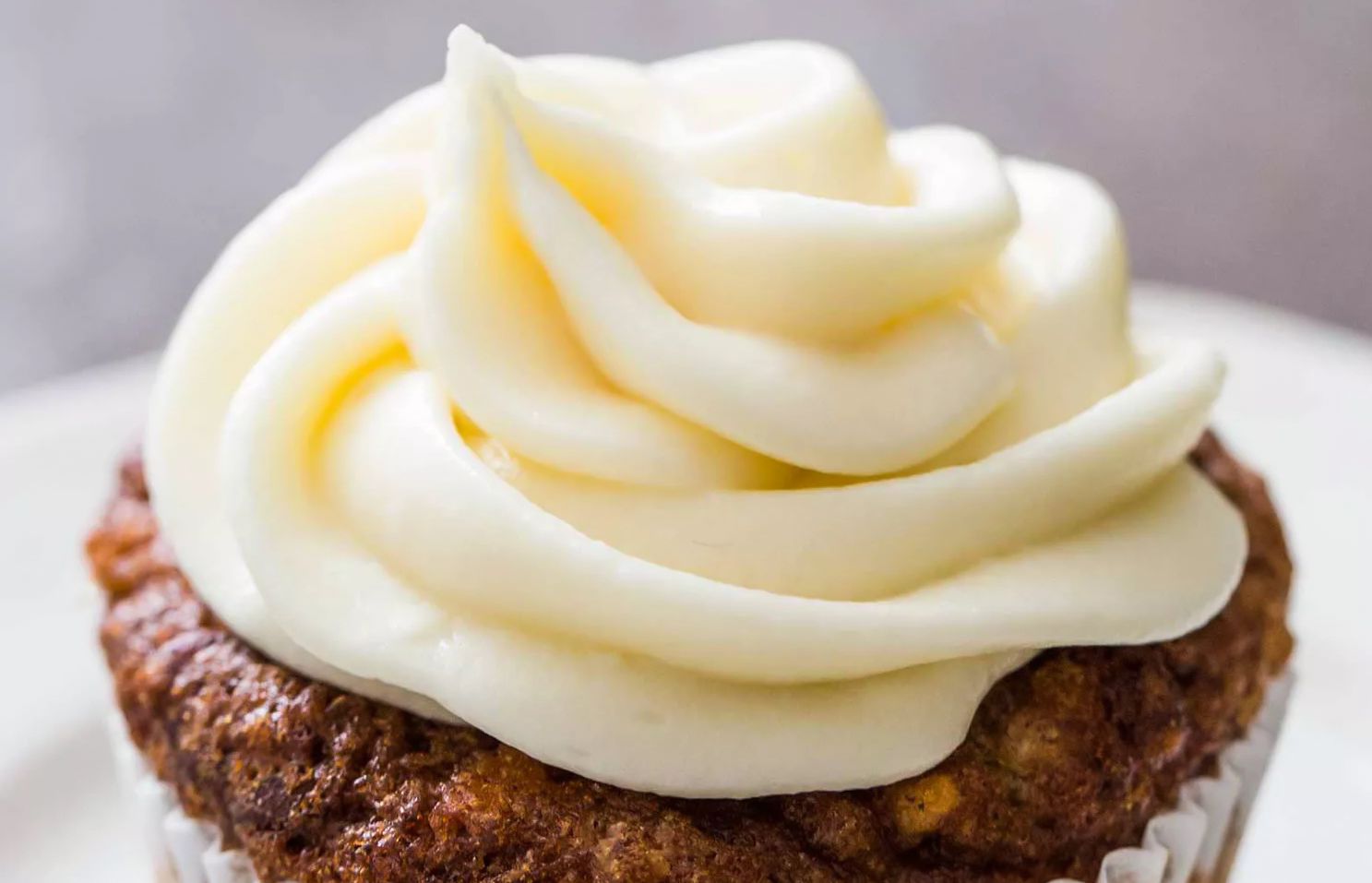 Cream cheese frosting piped on a cupcake