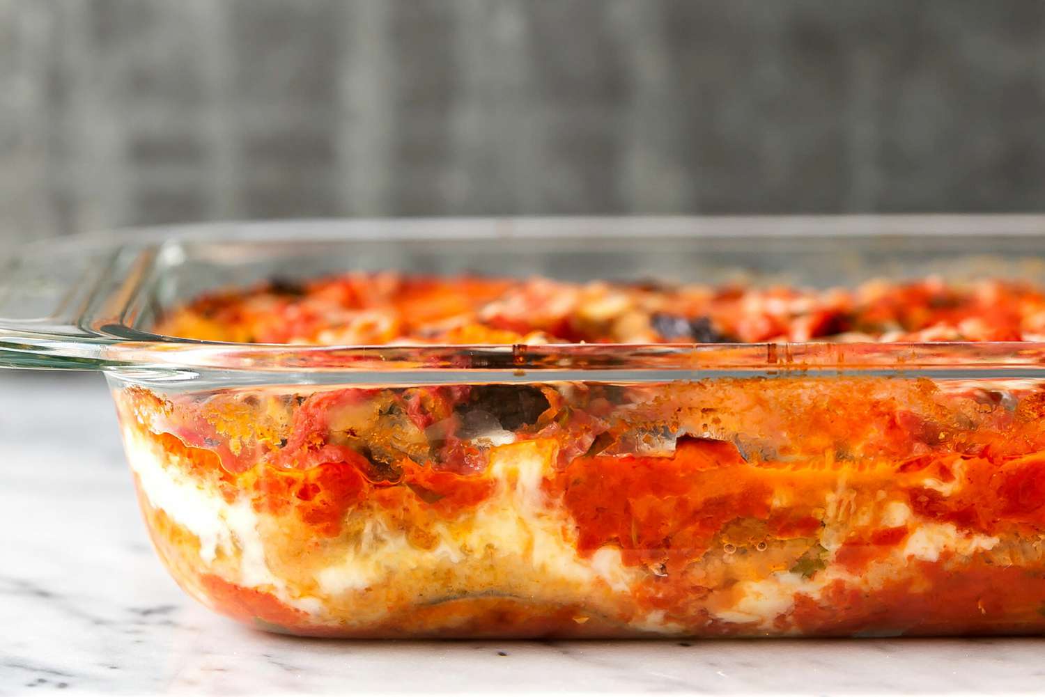 Casserole dish of baked eggplant parmesan