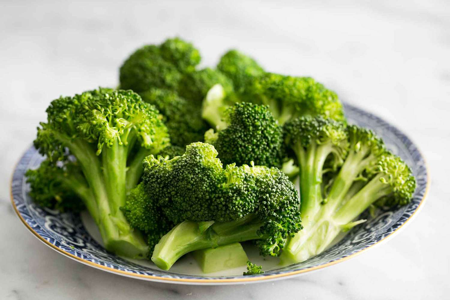 Steamed Broccoli on a blue and white plate