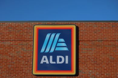 A sign for Aldi on a brick building