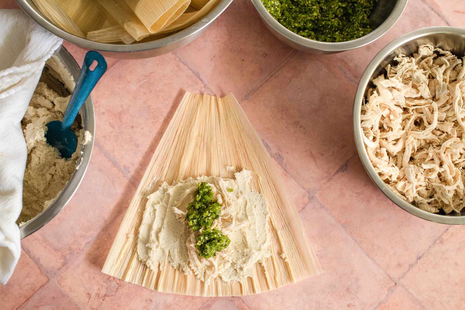 Making the Tamales: Chile Verde Added on Top of the Shredded Chicken 