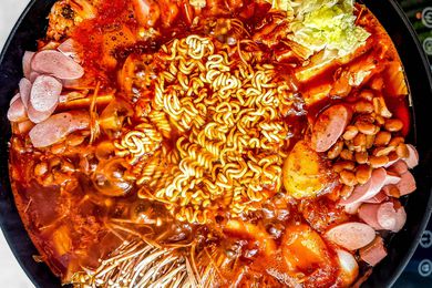 Budae Jjigae (Army Base Stew) in a large pot boiling on a portable induction stove