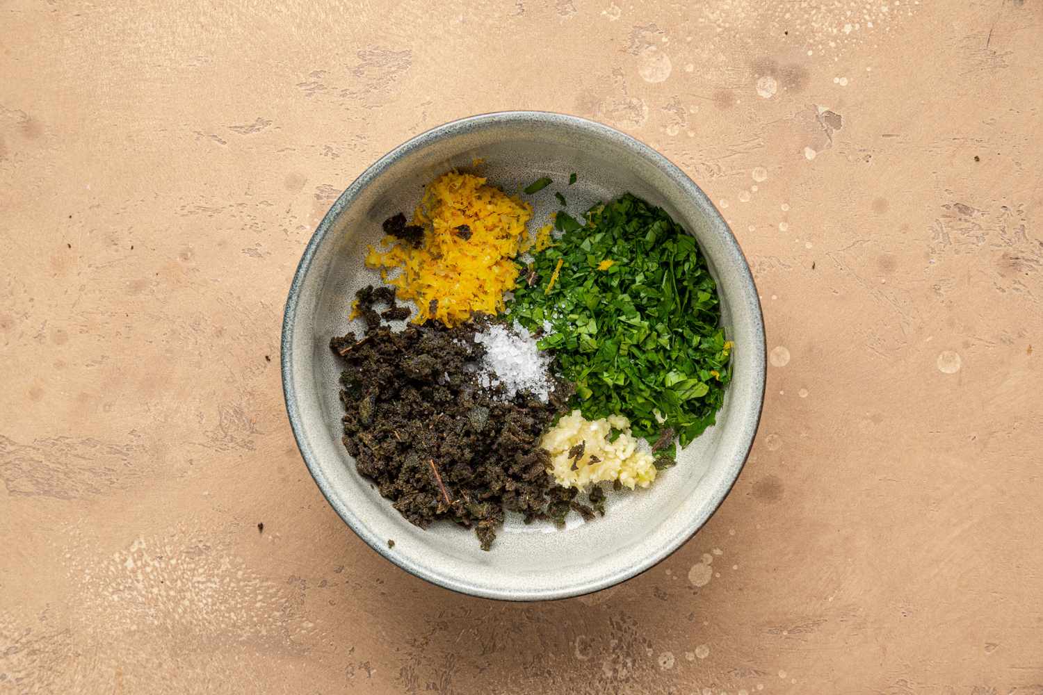 Bowl of Lemon Zest, Fried Sage, Parsley, Garlic, and Salt for Sage Gremolata