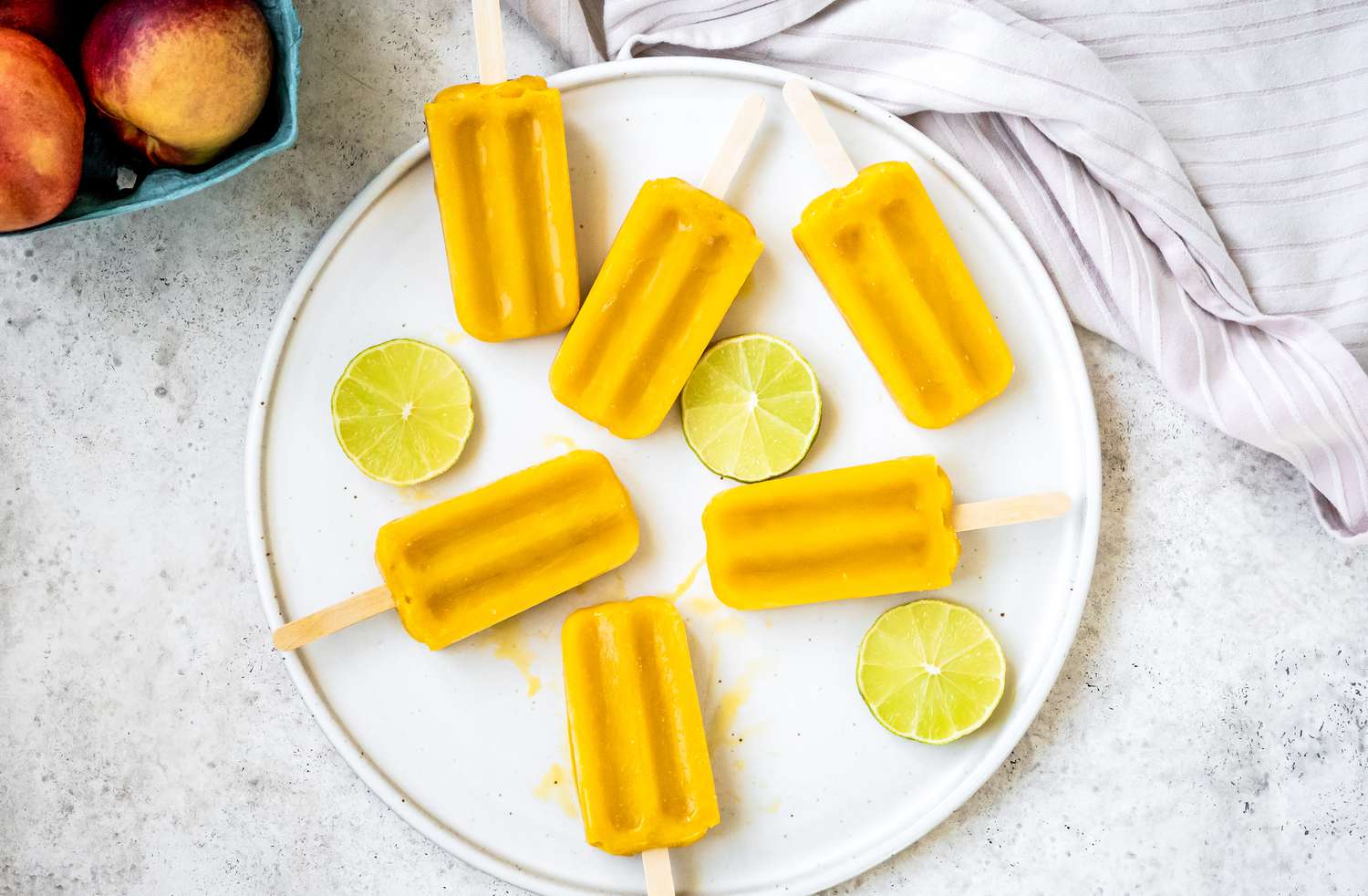 Peach Daiquiri Popsicles on a Plate with Lime Circles