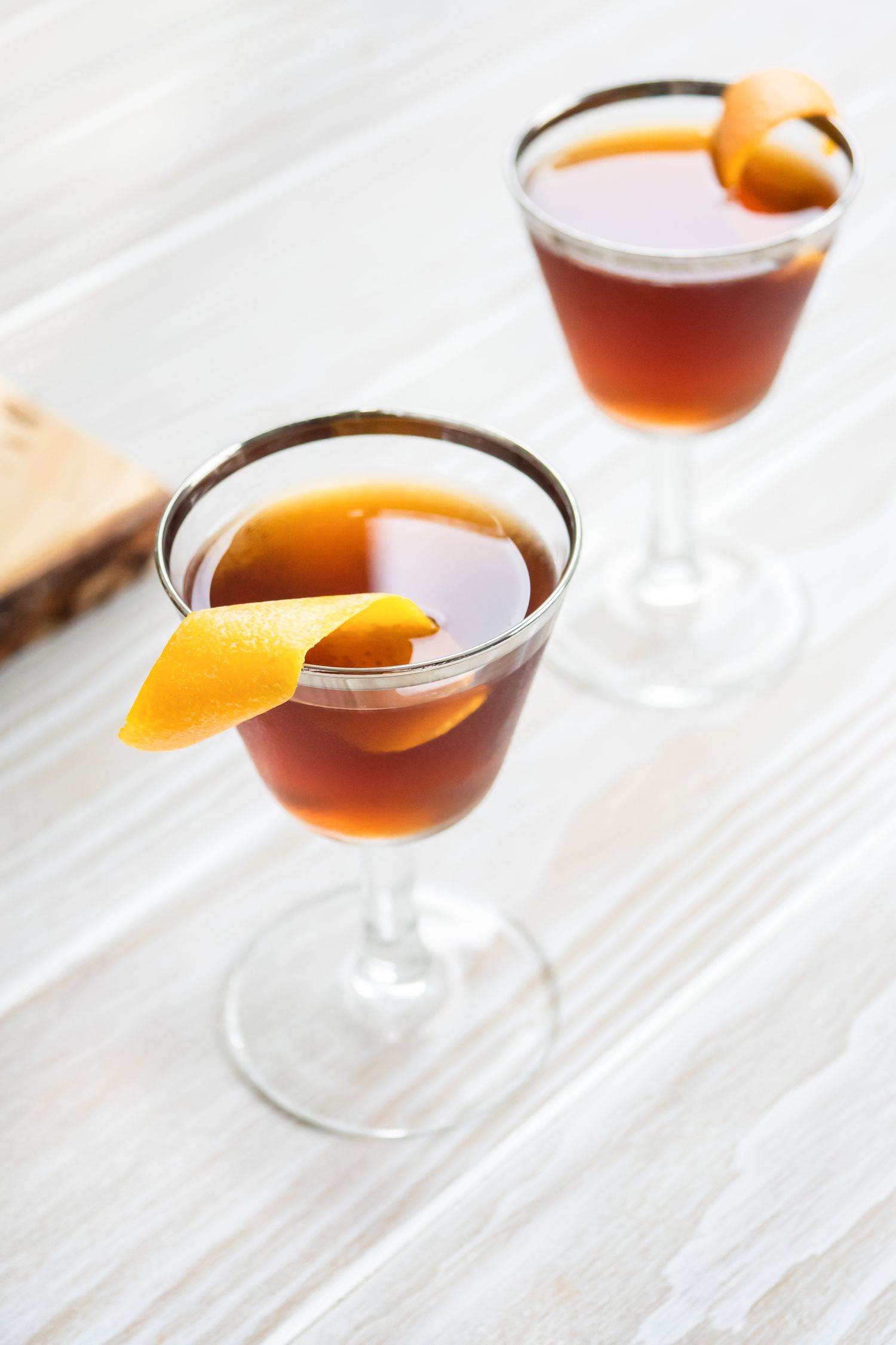 Glasses of Black Manhattan with Orange Peels