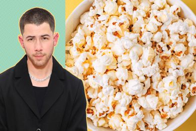 Nick Jonas next to a bowl full of popcorn