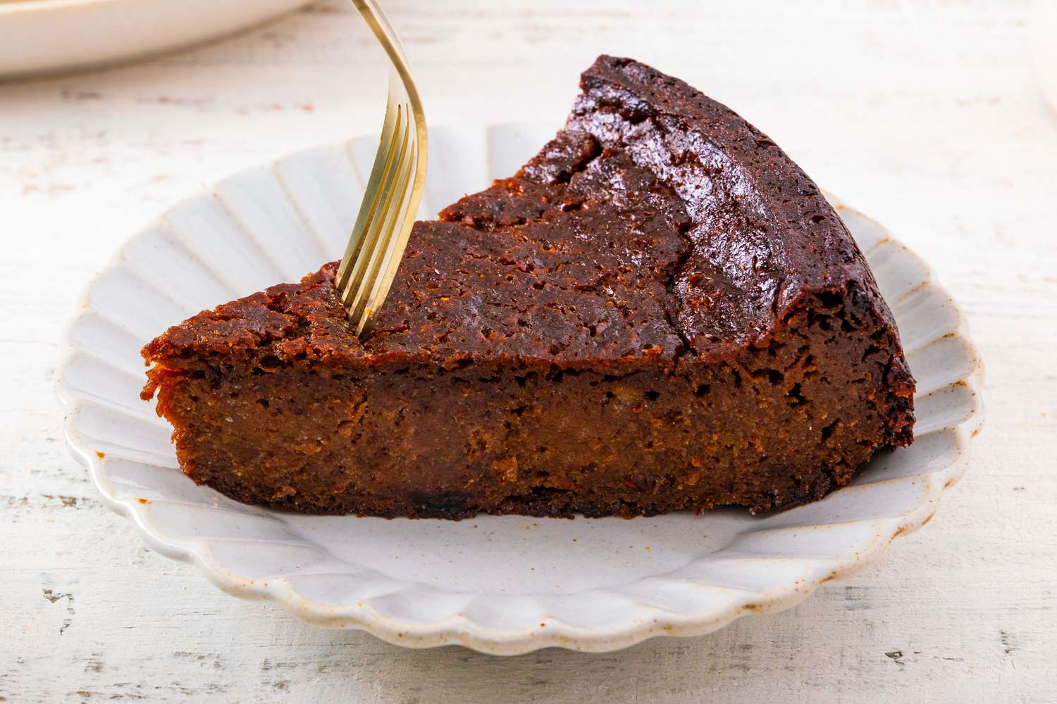 slice of Jamaican Black Cake on a plate with a fork