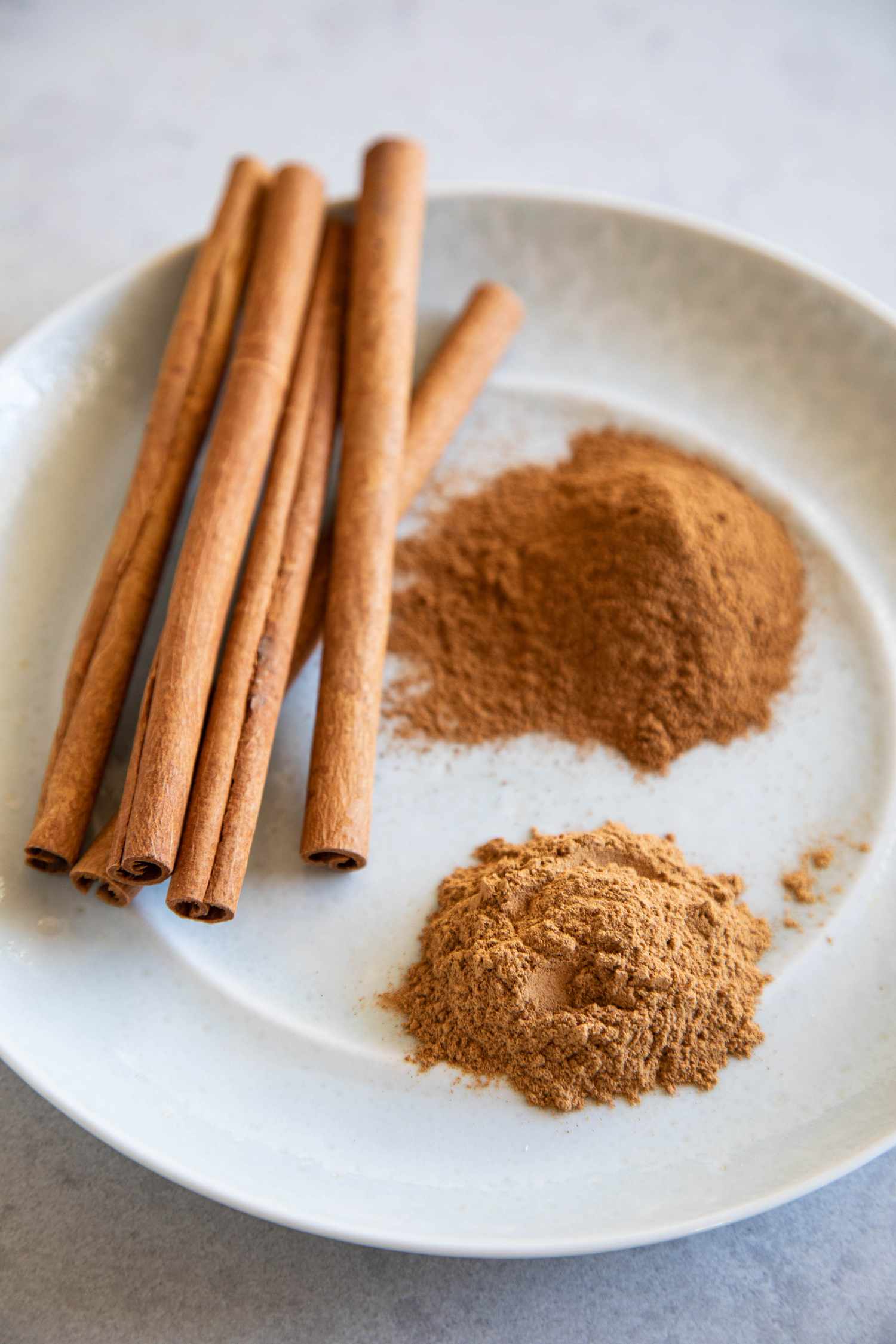 Three types of cinnamon on a white plate