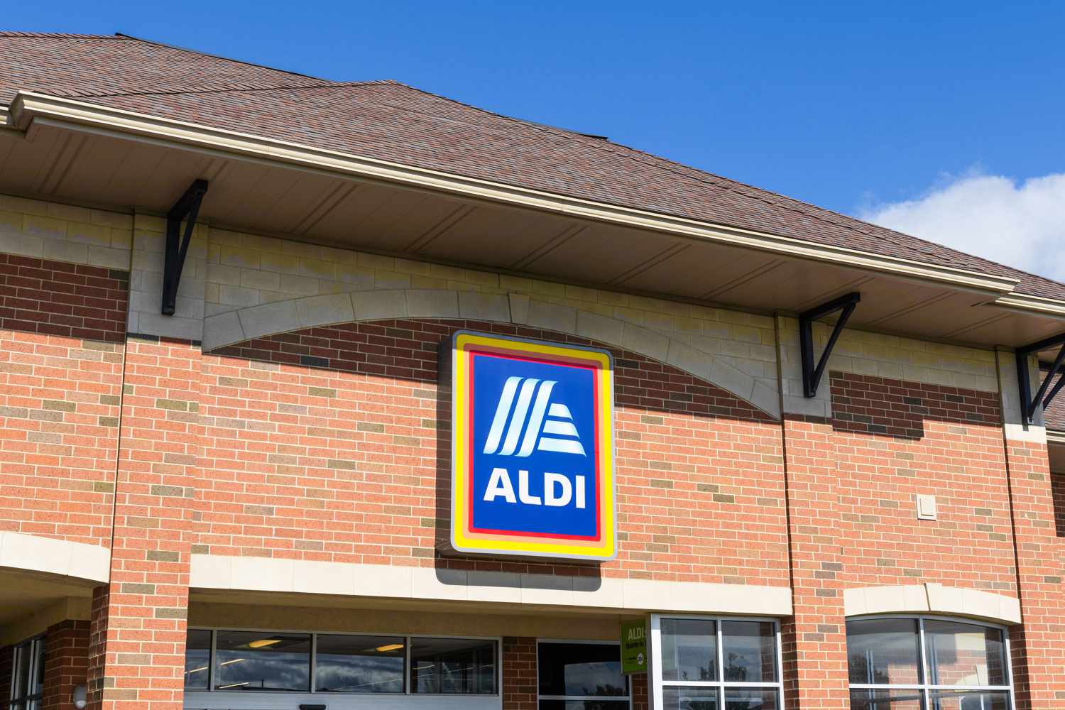 Aldi grocery store sign above the main entrance on a brick facade