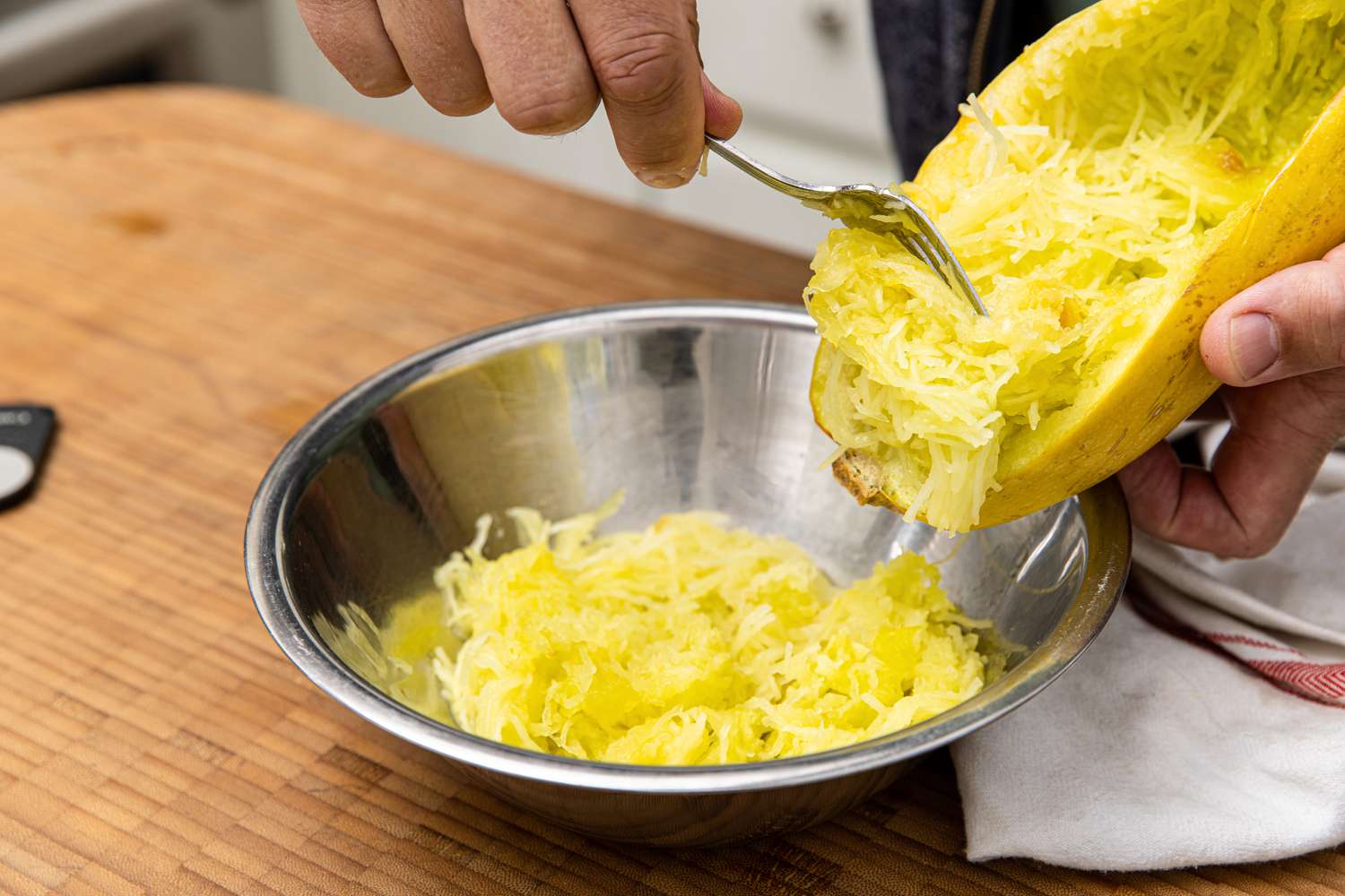 Spaghetti Squash Strips Scraped into a Bowl for Soup with Italian Sausage