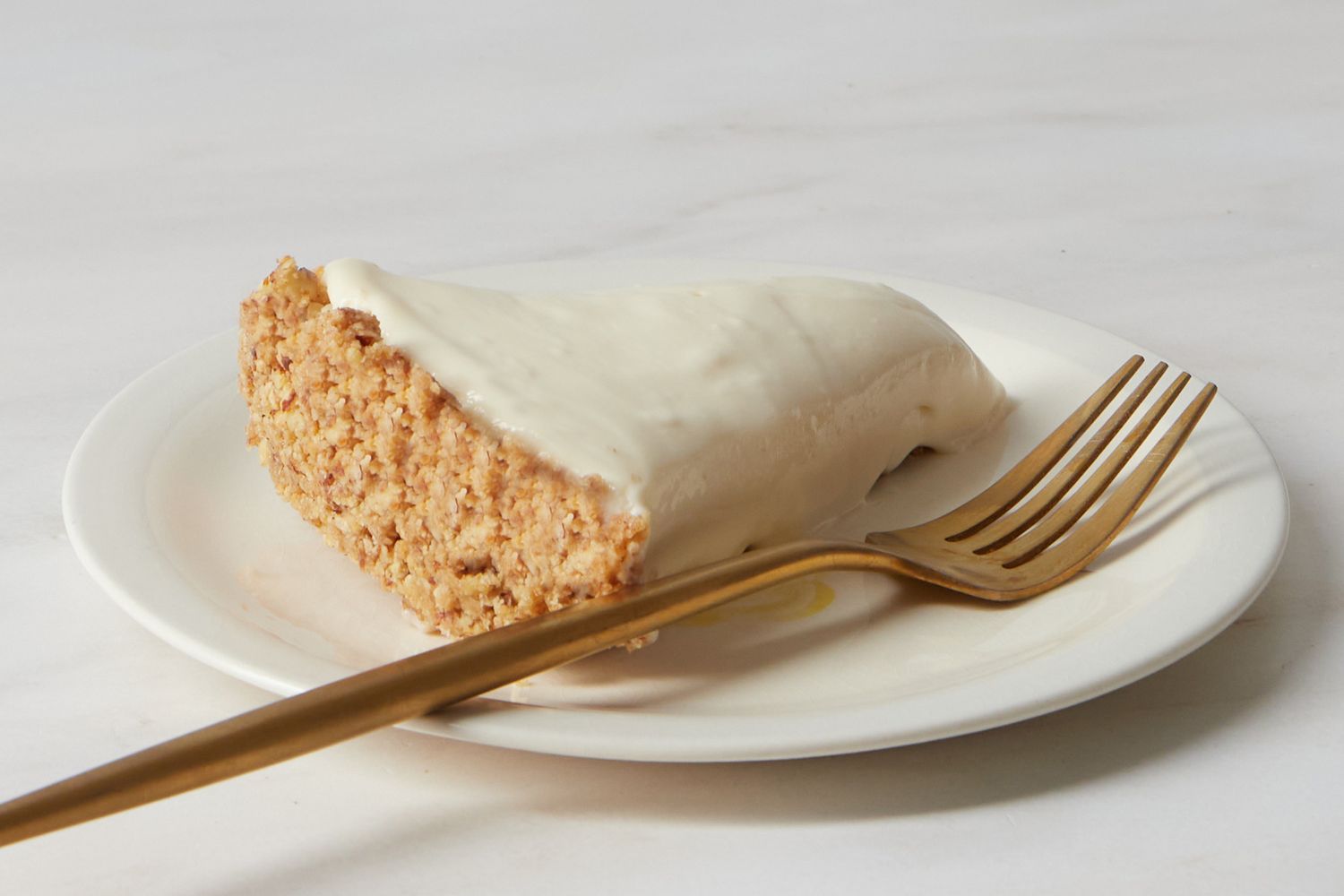 A slice of nobake cheesecake served on a white plate with a fork