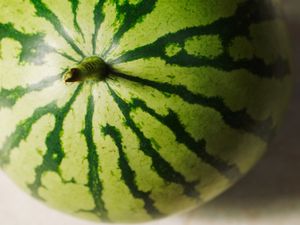 A watermelon with visible rind patterns placed on a surface
