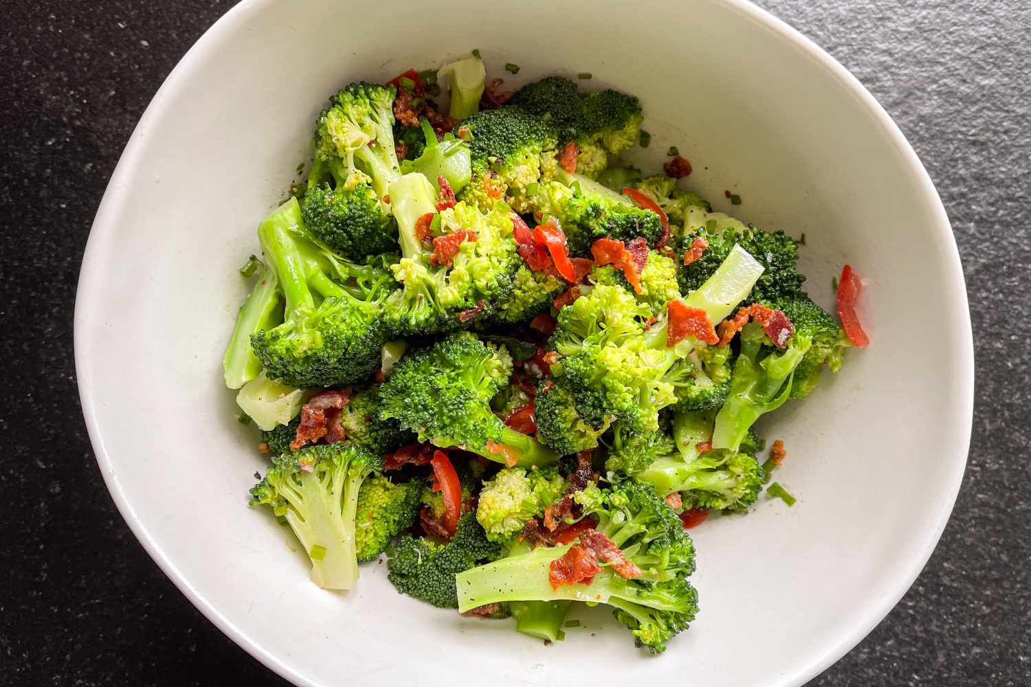 Overhead view of a white bowl with Jamie Oliver's broccoli salad