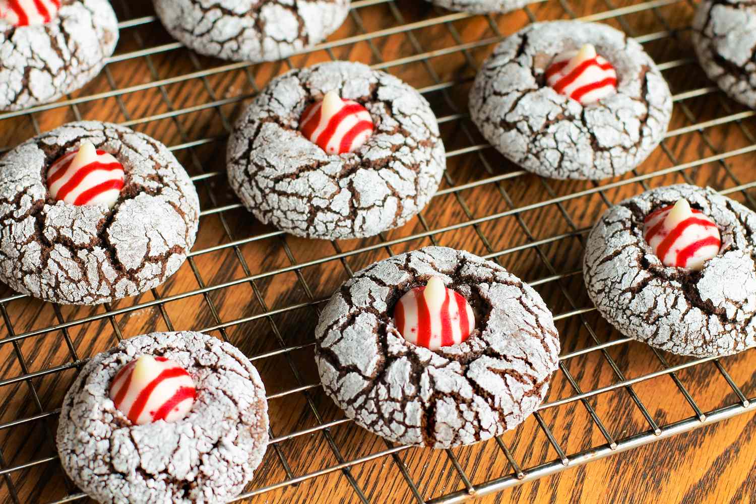 Crinkle cookies with striped candy decorations cooling on a wire rack