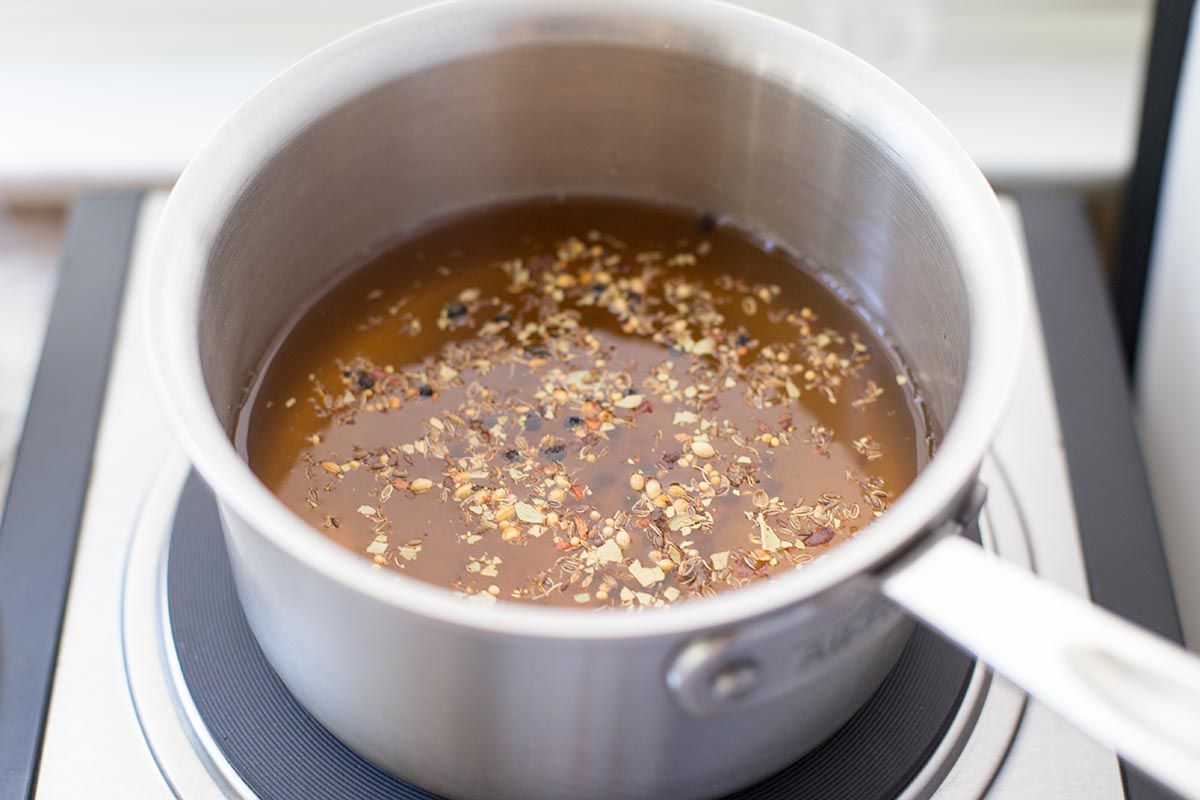 Make the brine for refrigerator pickles with these ingredients: vinegar, water, sugar, salt, and pickling spices