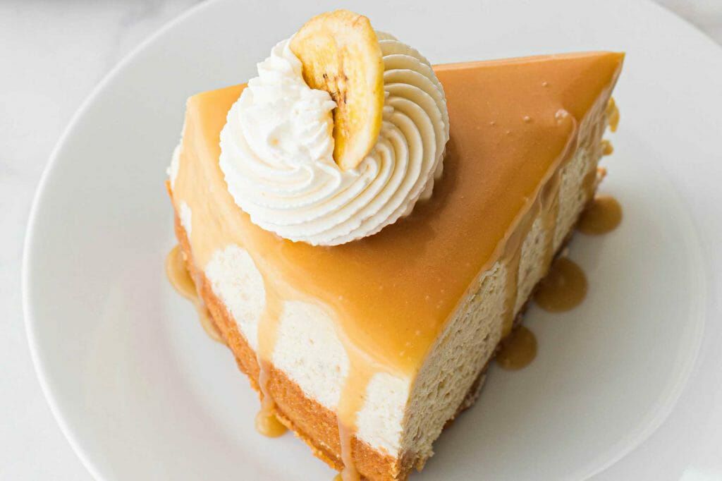 Banoffee Pie Cheesecake Recipe - slice of pie with cream and banana