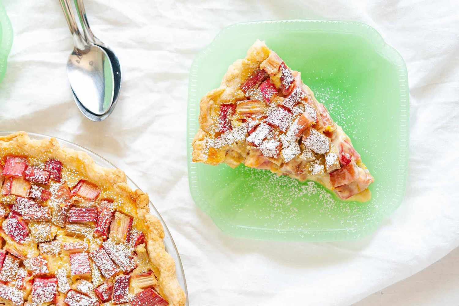 Old Fashioned Rhubarb Pie - pie with a slice taken out and sitting on a jadite plate