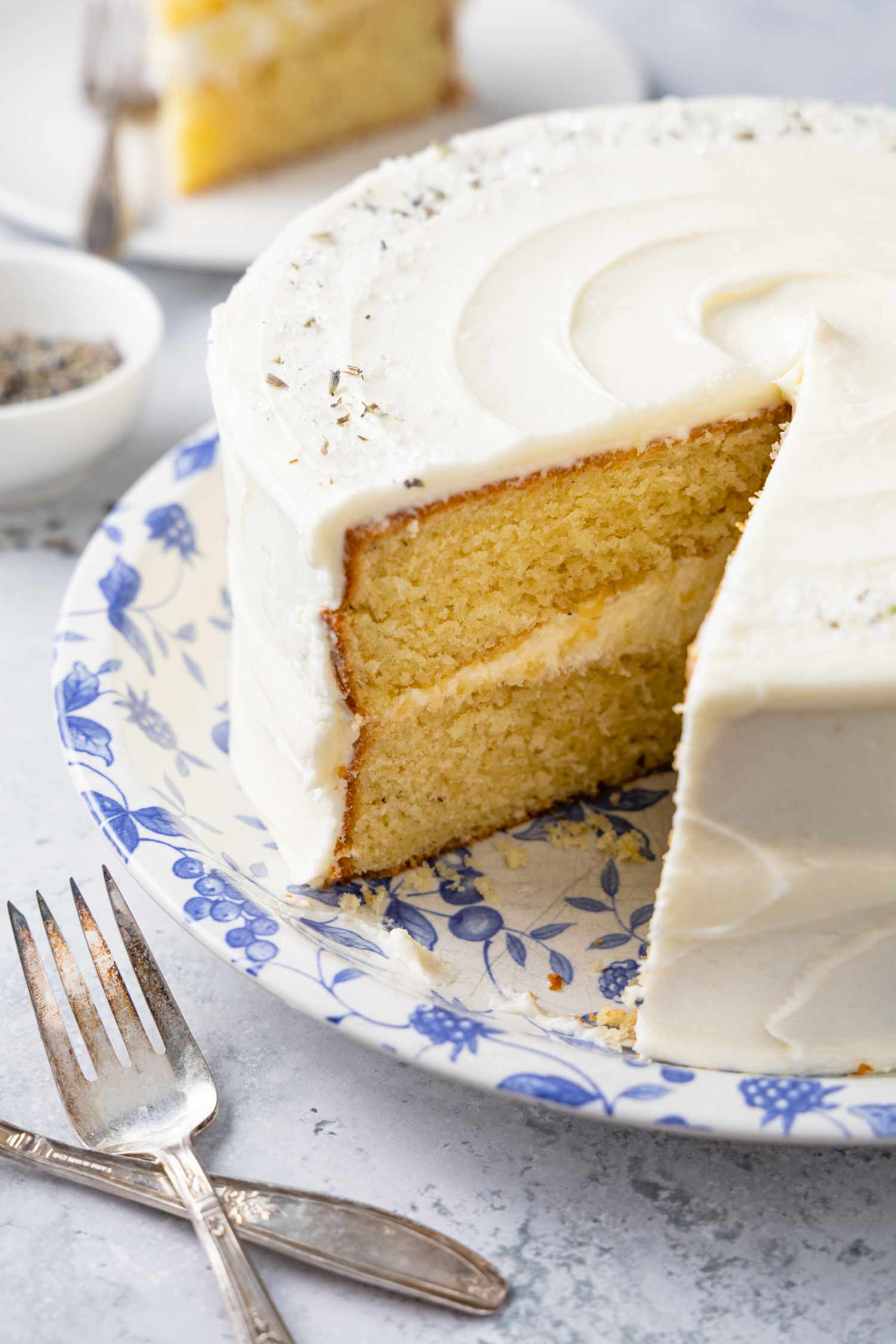 Lemon Lavender Cake with a Piece Cut Out Next to a Fork