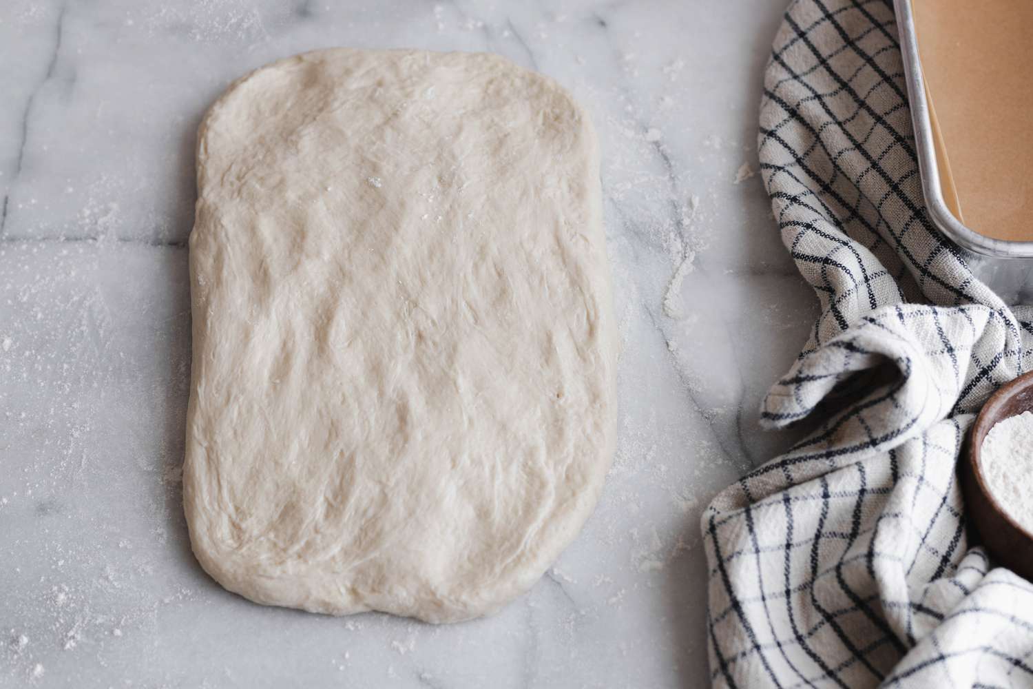 Dough Pressed on a Floured Surface until Shaped into a Rectangle for Sourdough Sandwich Loaf Recipe 