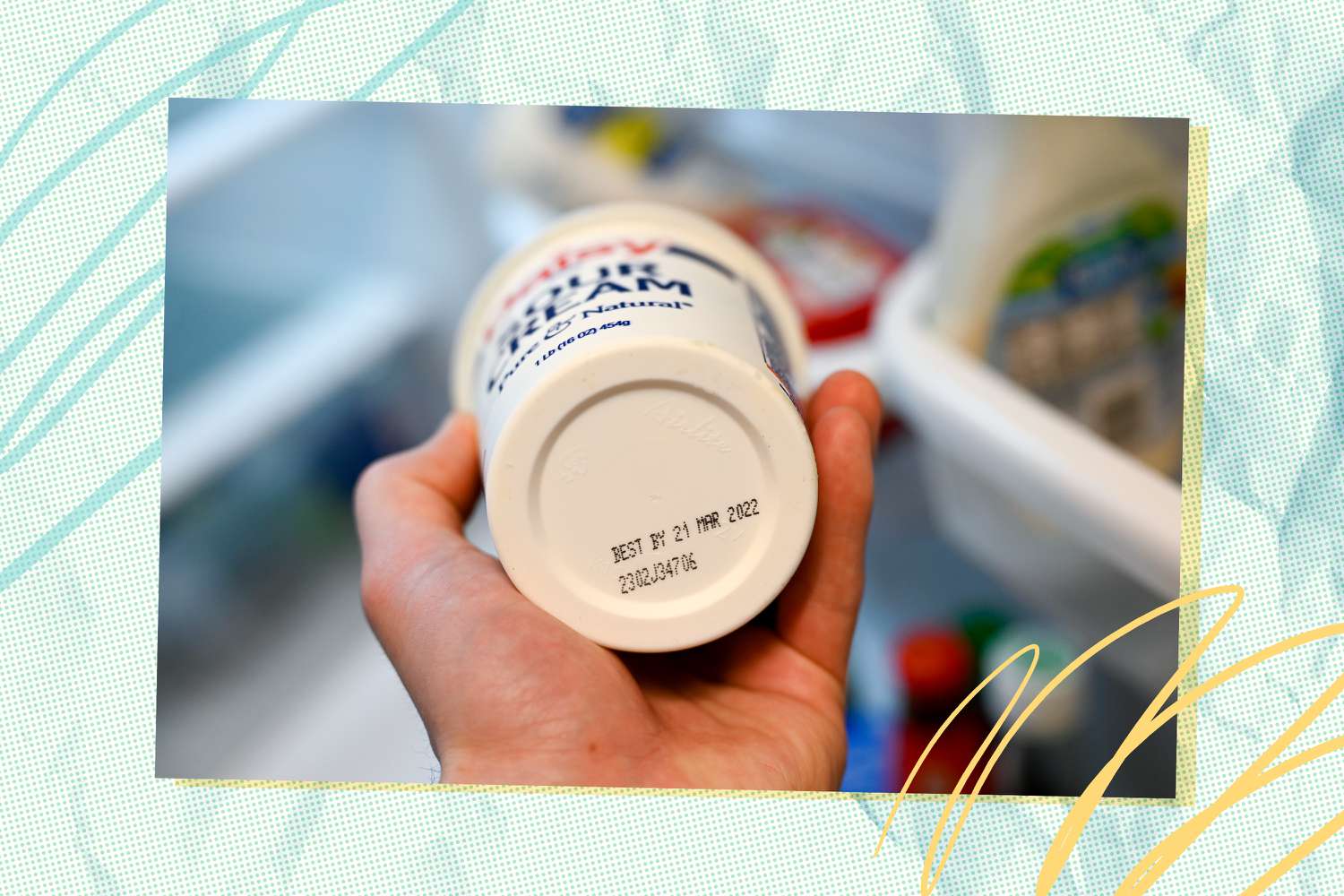 bottom of a tub of sour cream shows expiration date