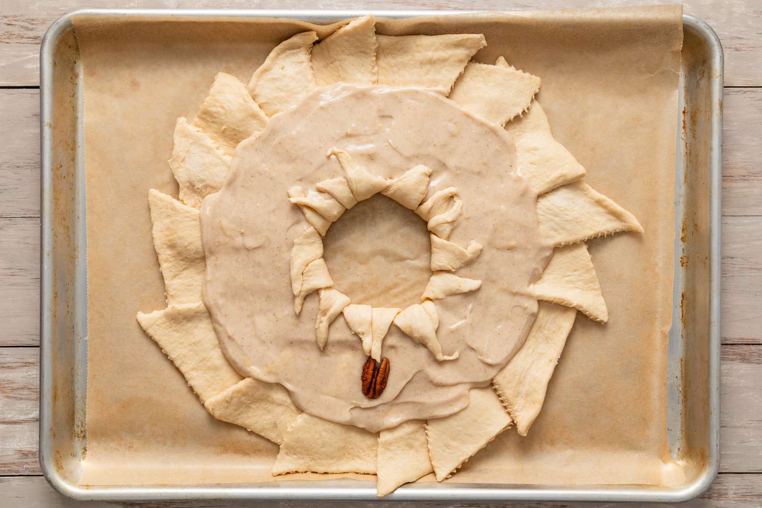 Inner edge of dough folded over the filling and the pecan placed on the filling for easy king cake recipe