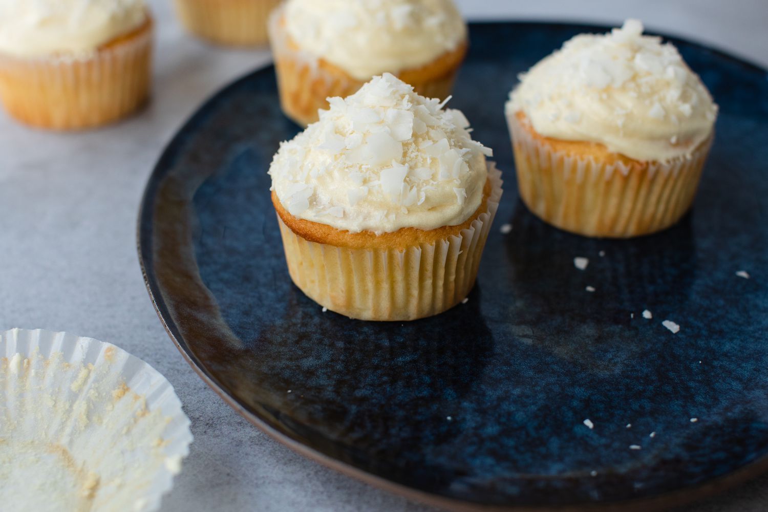 Coconut Cupcakes with Coconut Cream Cheese Frosting on a Plate