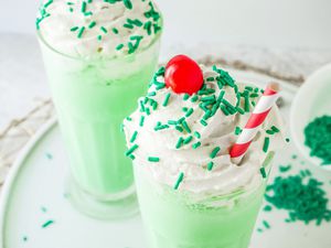 Copycat Shamrock Shake with green sprinkles, a cherry, and a straw.