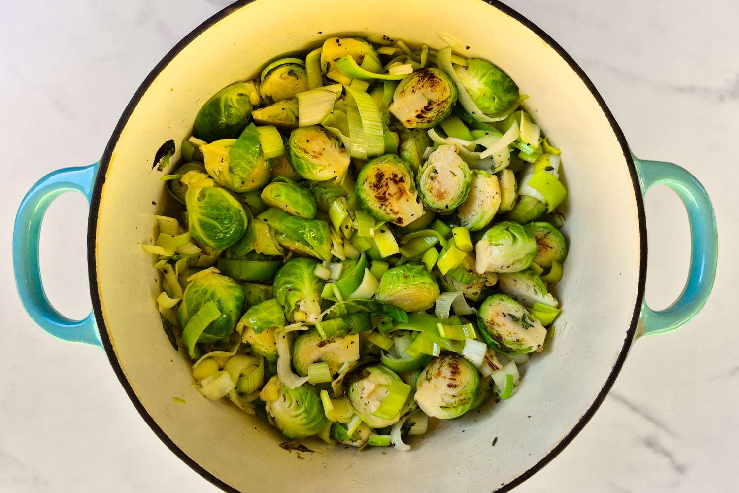 Brussels sprouts in a cooking pot with seasonings