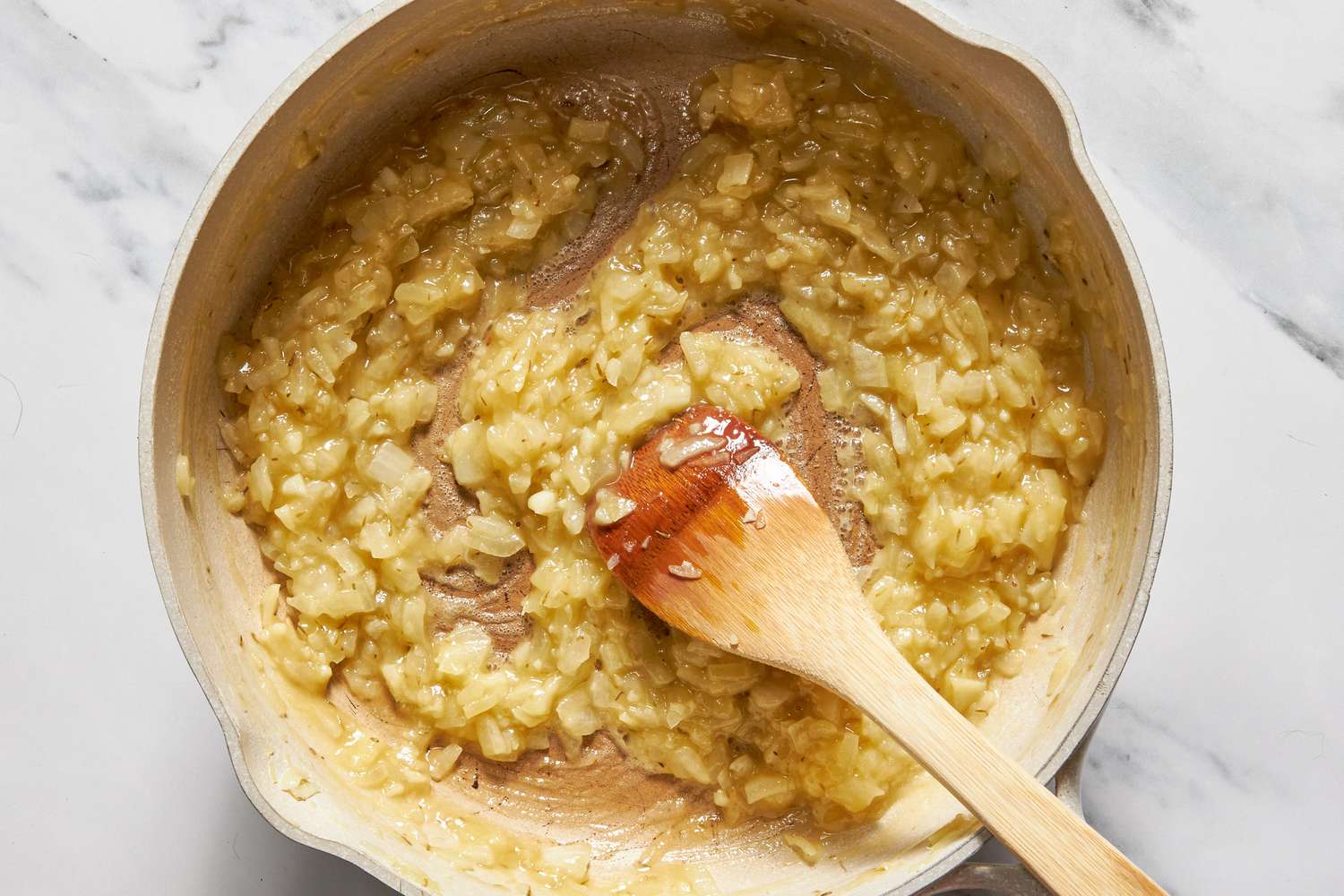Broth added to flour and onion mix for chicken cobbler with cheddar bay biscuit top recipe