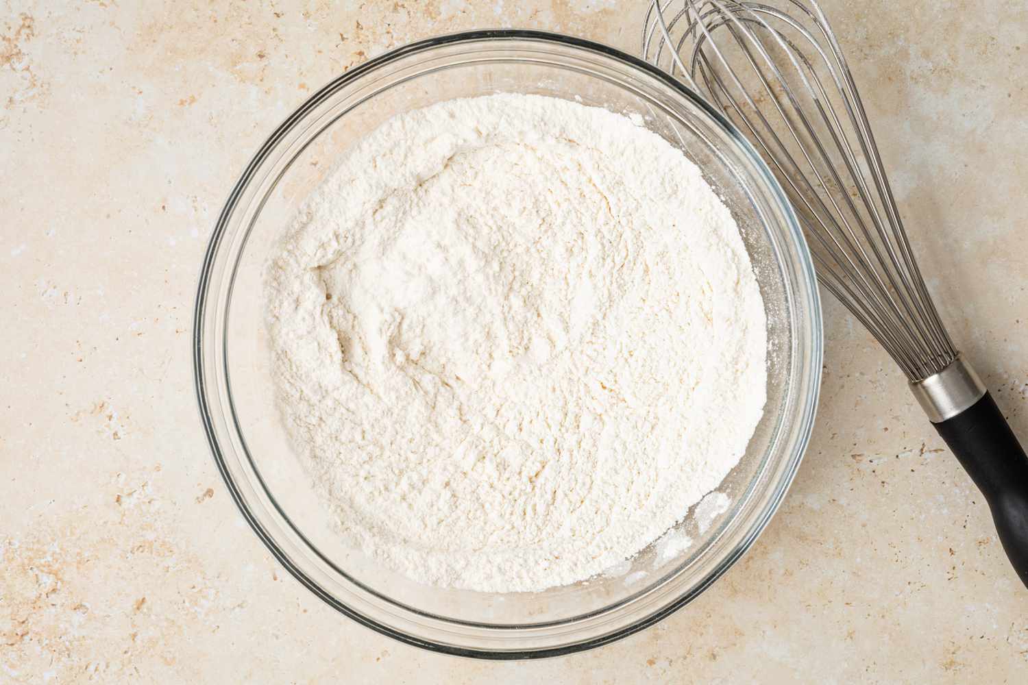 Bowl of Flour Next to a Whisk for Peanut Butter Cup Cookies 