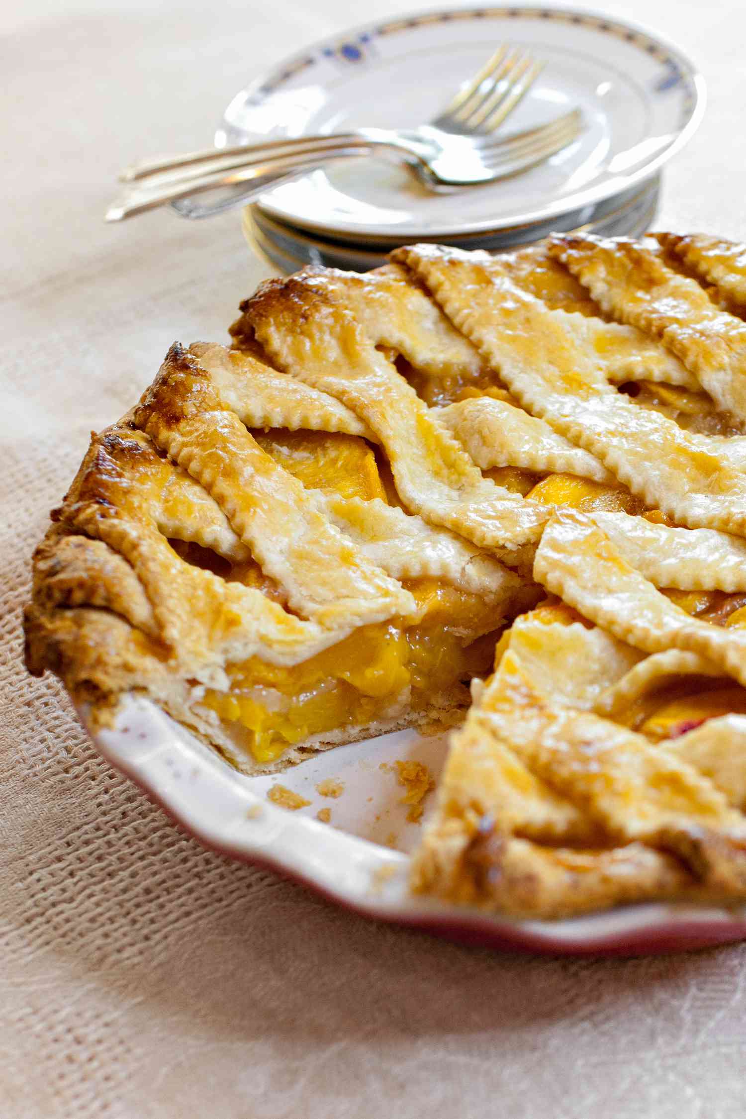 Peach Pie in a Pie Dish with a Piece Missing Made Using Pie Dough Made by Hand 