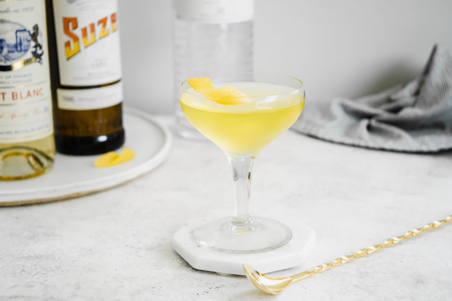 White Negroni with Ingredients in Background