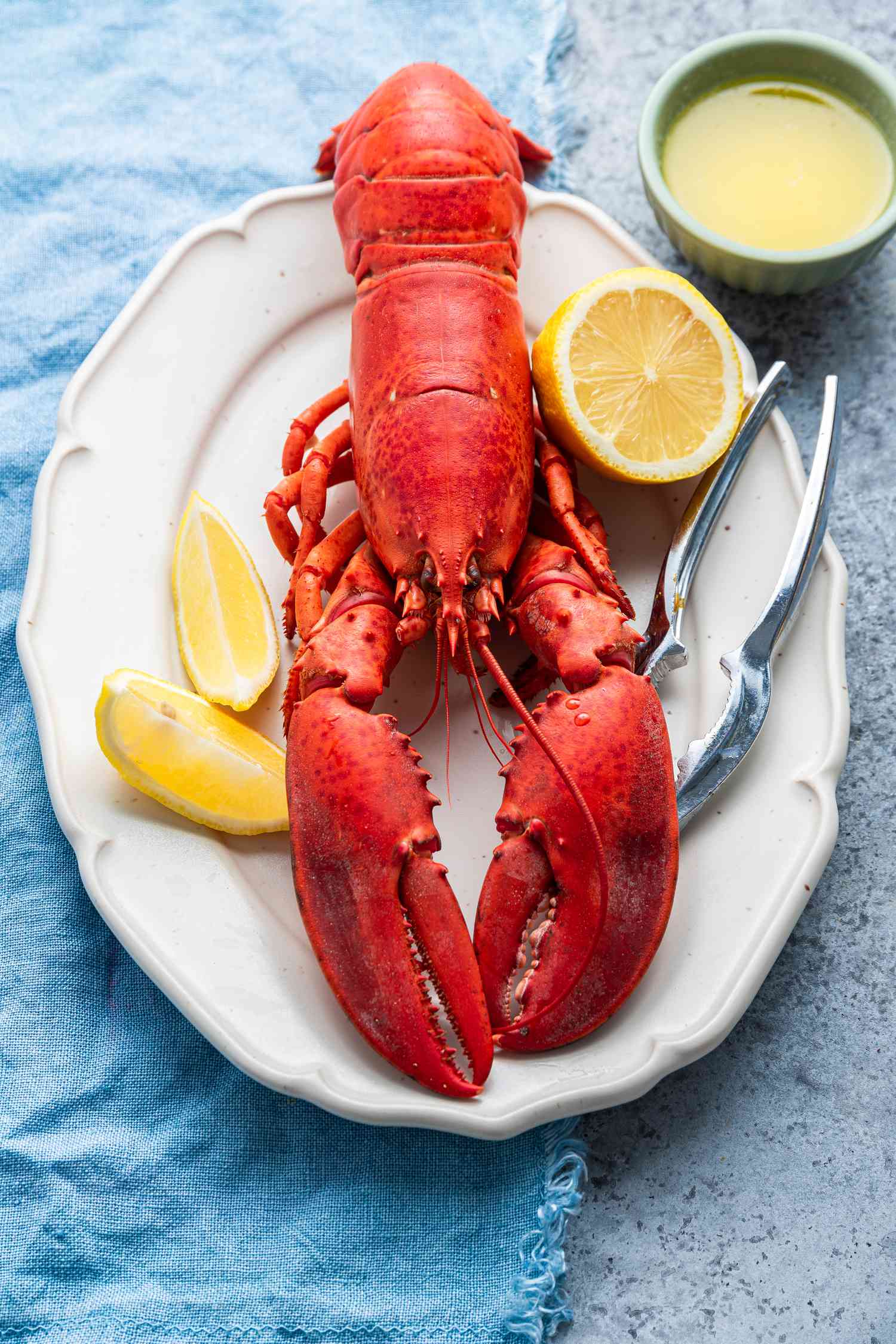 Plate of Lobster with Lemon Halves and a Bowl of Butter Sauce