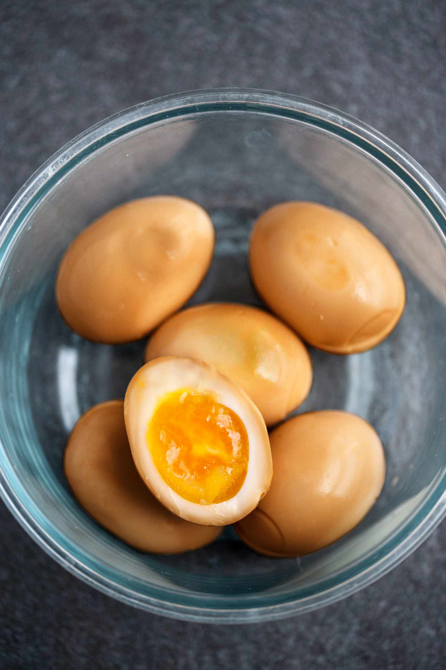 Soy Sauce Eggs in Bowl with an Egg Cut in Half