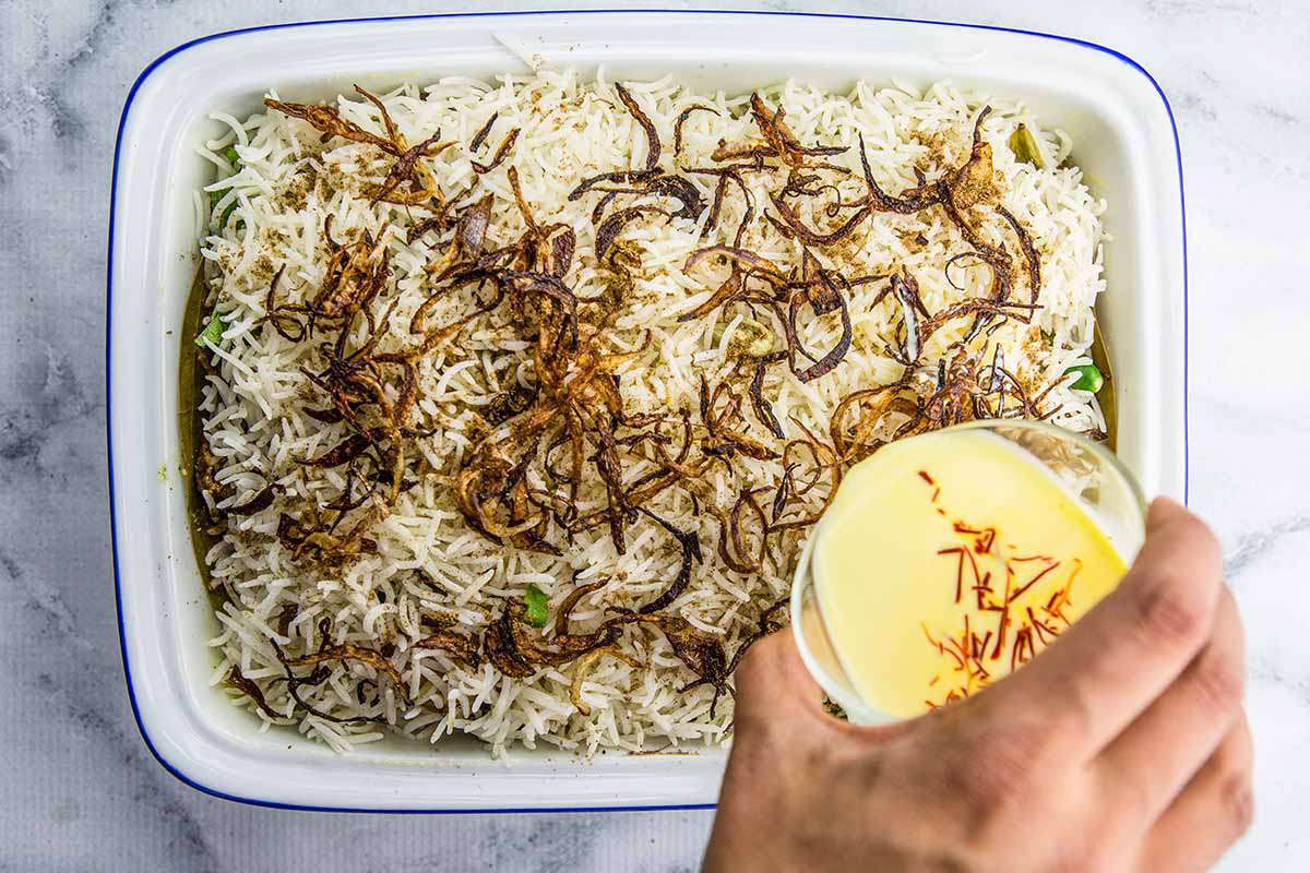 Hyderabadi Chicken Biryani pour the saffron milk over it