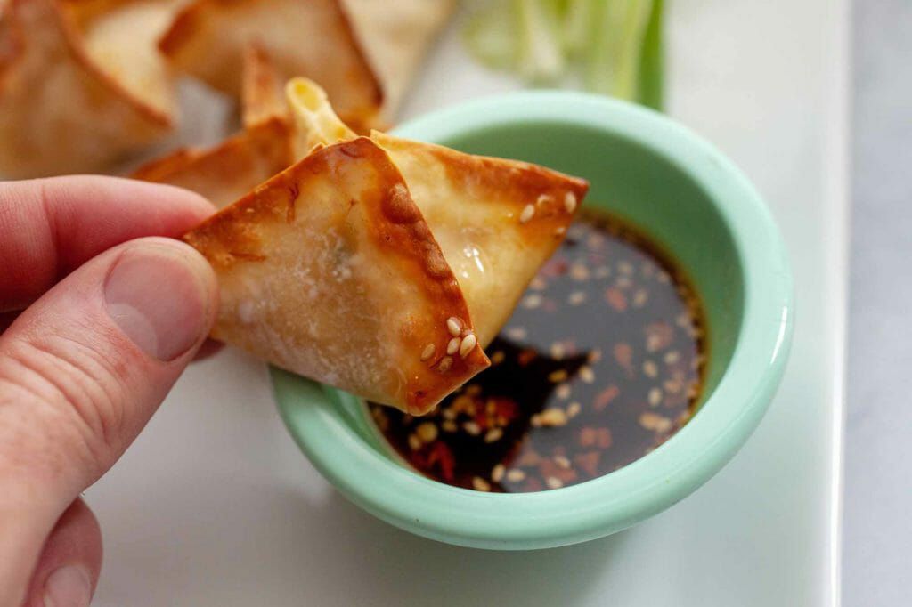 Dipping a homemade fried wonton
