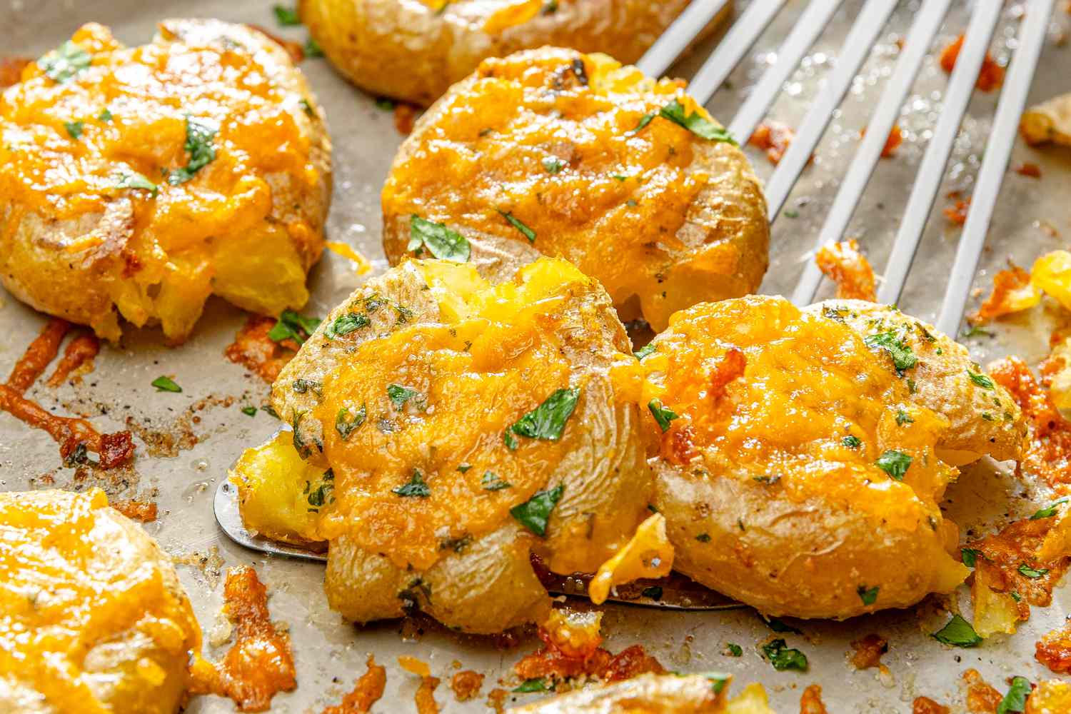 Cheesy baked smashed potatoes topped with herbs
