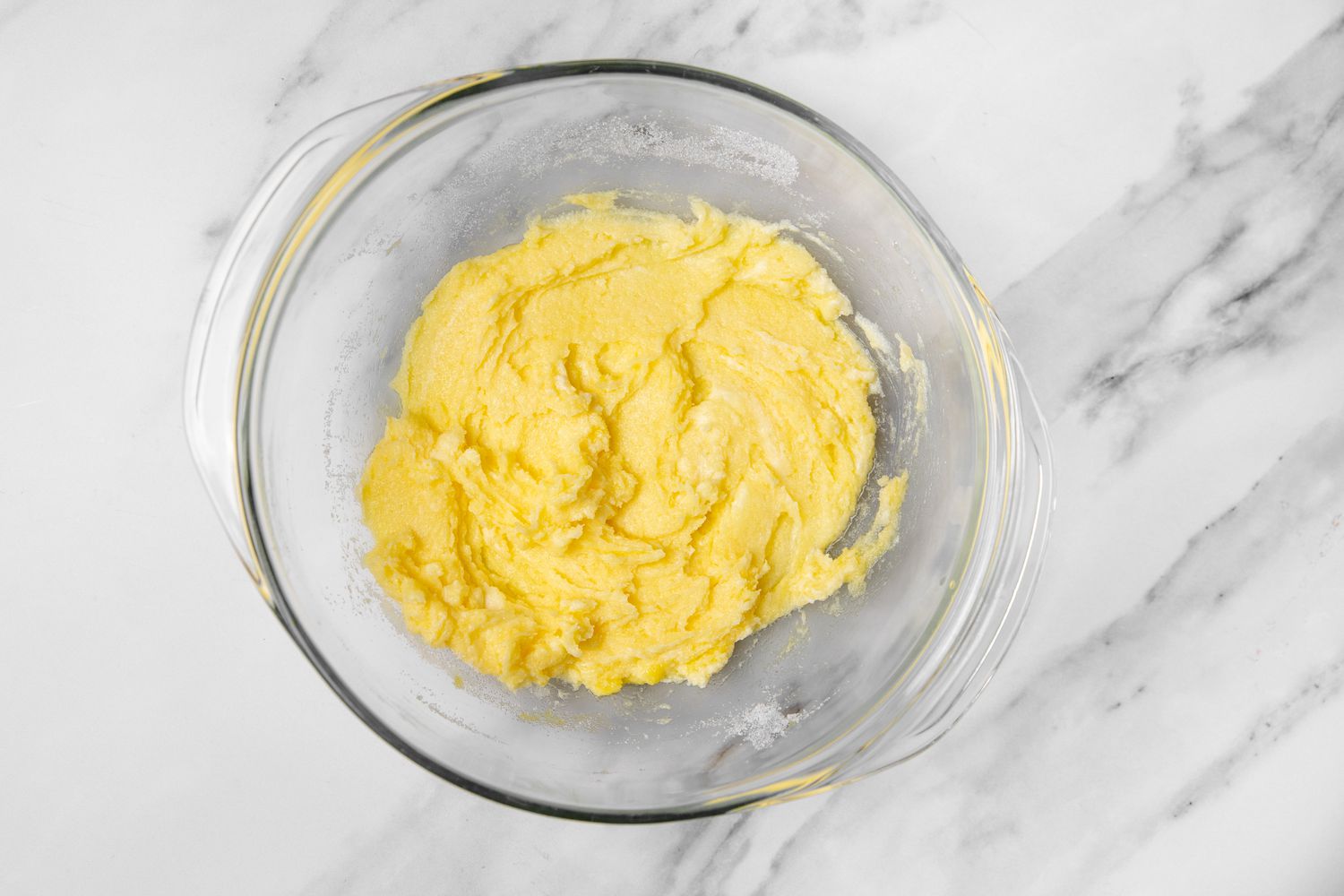 sugar, butter, salt and egg mixed together in a bowl for german plum tart recipe